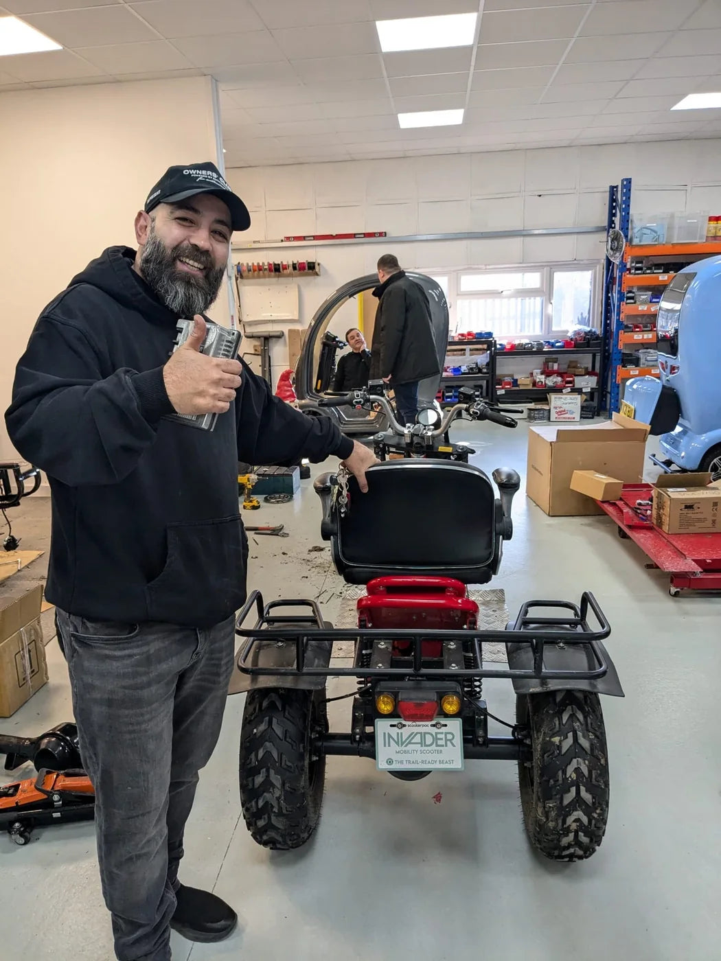 Humber Mobility Centre workshop team member with a Scooterpac Invader off-road mobility scooter in the Hull service centre